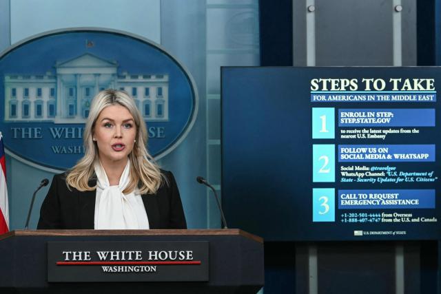 White House Press Secretary Karoline Leavitt speaks alongside a screen displaying information for US citizens seeking assistance in the Middle East, during a press briefing in the Brady Briefing Room of the White House in Washington, DC, on March 4, 2026. (Photo by ANDREW CABALLERO-REYNOLDS / AFP)