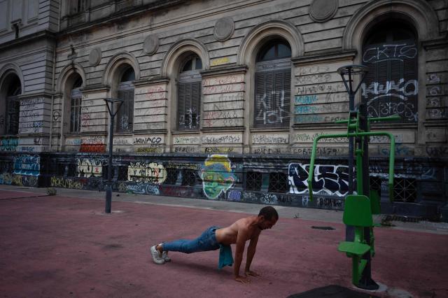 A man excercises outside the building of the Universidad de la República (UDELAR) Law School in Montevideo on March 4, 2026. (Photo by Eitan ABRAMOVICH / AFP)