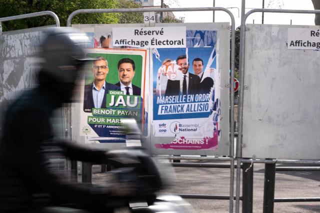 A photo shows campaign posters of Marseille mayoral candidates incumbent mayor Benoit Payan for the left-wing coalition Printemps Marseillais (L) and Franck Allisio of the far-right Rassemblement National (RN) party, ahead of France's municipal elections in Marseille, southeastern France, on March 4, 2026. French voters head to the polls for municipal elections on March 15 and 22, 2026. (Photo by Elodie CLEMENT / AFP)