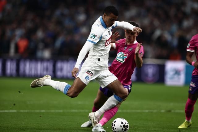 Marseille's English forward #10 Mason Greenwood is tackled during the French Cup quarter final football match between Olympique de Marseille (OM) and Toulouse FC at the Stade Velodrome stadium in Marseille, southern France on March 4, 2026. (Photo by Thibaud MORITZ / AFP)