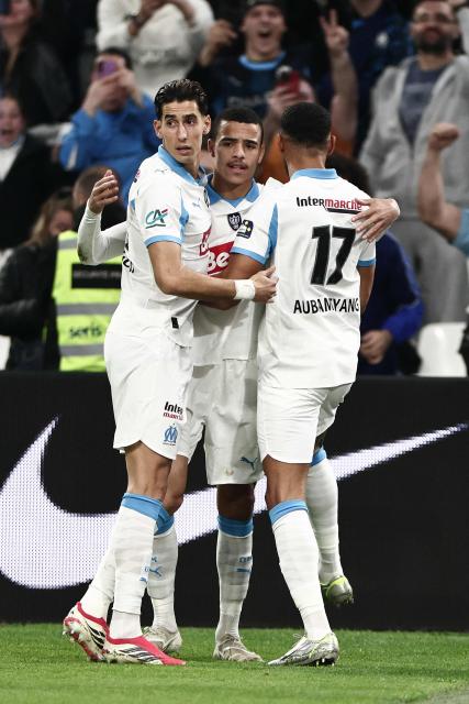 Marseille's English forward #10 Mason Greenwood celebrates with teammates after scoring a penalty during the French Cup quarter final football match between Olympique de Marseille (OM) and Toulouse FC at the Stade Velodrome stadium in Marseille, southern France on March 4, 2026. (Photo by Thibaud MORITZ / AFP)
