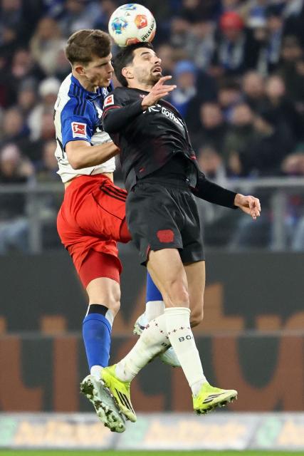 Hamburg's Croatian defender #44 Luka Vuskovic (L) and Bayer Leverkusen's French forward #11 Martin Terrier both jump to head the ball during the German first division Bundesliga football match between Hamburger SV and Bayer 04 Leverkusen in Hamburg, northern Germany on March 4, 2026. (Photo by IBRAHIM OT / AFP) / DFL REGULATIONS PROHIBIT ANY USE OF PHOTOGRAPHS AS IMAGE SEQUENCES AND/OR QUASI-VIDEO
