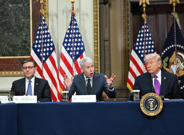 US President Donald Trump (R) and House Speaker Mike Johnson (L) listen to Energy Secretary Chris Wright during a roundtable on Ratepayer Protection Pledge in the Indian Treaty Room at the Eisenhower Executive Office Building on the White House campus in Washington, DC, on March 4, 2026. (Photo by ANDREW CABALLERO-REYNOLDS / AFP)