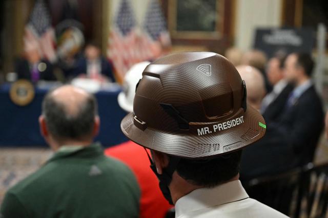 An attendee wears a hard hat reading "Mr. President" as US President Donald Trump holds a roundtable on Ratepayer Protection Pledge in the Indian Treaty Room at the Eisenhower Executive Office Building on the White House campus in Washington, DC, on March 4, 2026. (Photo by ANDREW CABALLERO-REYNOLDS / AFP)