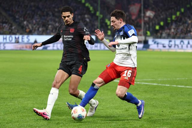 Bayer Leverkusen's English defender #04 Jarell Quansah (L) and Hamburg's Georgian defender #16 Giorgi Gocholeishvili vie for the ball during the German first division Bundesliga football match between Hamburger SV and Bayer 04 Leverkusen in Hamburg, northern Germany on March 4, 2026. (Photo by IBRAHIM OT / AFP) / DFL REGULATIONS PROHIBIT ANY USE OF PHOTOGRAPHS AS IMAGE SEQUENCES AND/OR QUASI-VIDEO