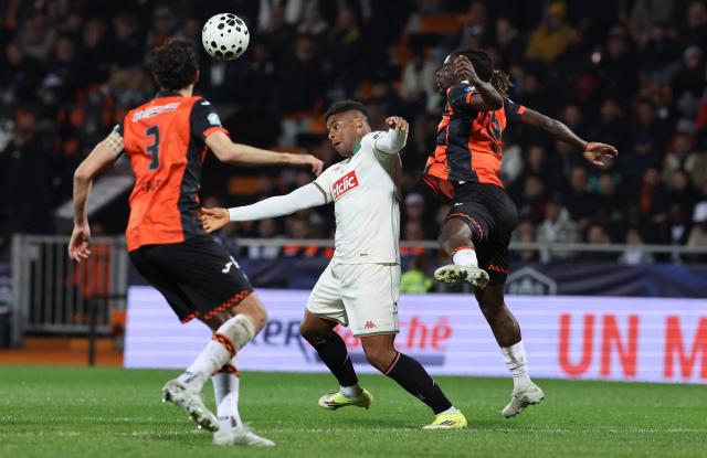 Lorient's Ivorian defender #05 Bamo Meite and Lorient's Tunisian defender #03 Montassar Talbi fights for the ball with Nice's Spanish forward #90 Kevin Carlos during the French Cup quarter final football match between FC Lorient and OGC Nice at the Stade du Moustoir stadium in Lorient, western France on March 4, 2026. (Photo by Fred TANNEAU / AFP)