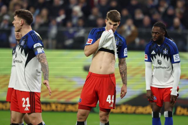 Hamburg's Croatian defender #44 Luka Vuskovic (C) wipes blood from his face after sustaining an injury during the German first division Bundesliga football match between Hamburger SV and Bayer 04 Leverkusen in Hamburg, northern Germany on March 4, 2026. (Photo by IBRAHIM OT / AFP) / DFL REGULATIONS PROHIBIT ANY USE OF PHOTOGRAPHS AS IMAGE SEQUENCES AND/OR QUASI-VIDEO