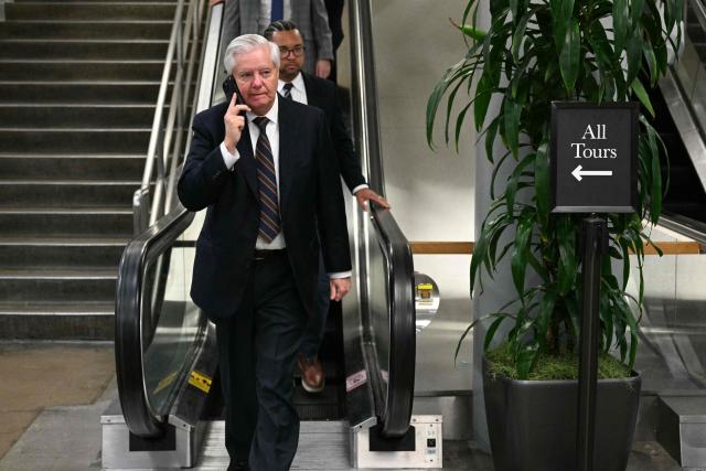 US Senator Lindsey Graham (R-SC) speaks on the phone on Capitol Hill in Washington, DC, on March 4, 2026. The US Senate is set to vote on March 4 on a resolution aimed at curbing President Donald Trump's authority to continue military strikes on Iran, in the first congressional test of support for a conflict launched without explicit approval from lawmakers. (Photo by Jim WATSON / AFP)