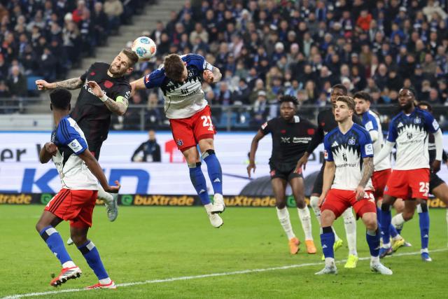 Bayer Leverkusen's German midfielder #08 Robert Andrich (2nd L) and Hamburg's German midfielder #21 Nicolai Remberg both jump to head the ball during the German first division Bundesliga football match between Hamburger SV and Bayer 04 Leverkusen in Hamburg, northern Germany on March 4, 2026. (Photo by IBRAHIM OT / AFP) / DFL REGULATIONS PROHIBIT ANY USE OF PHOTOGRAPHS AS IMAGE SEQUENCES AND/OR QUASI-VIDEO
