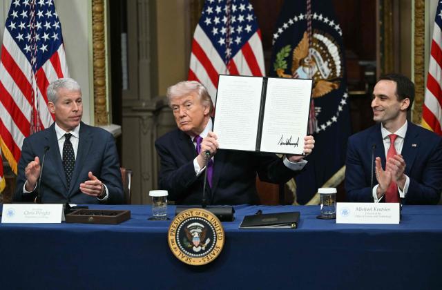 US President Donald Trump shows a proclamation he signed during a roundtable on Ratepayer Protection Pledge as Energy Secretary Chris Wright (L) and Michael Kratsios (R), director of the White House Office of Science and Technology Policy, applaud in the Indian Treaty Room at the Eisenhower Executive Office Building on the White House campus in Washington, DC, on March 4, 2026. (Photo by ANDREW CABALLERO-REYNOLDS / AFP)