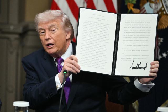 US President Donald Trump shows a proclamtion he signed during a roundtable on Ratepayer Protection Pledge in the Indian Treaty Room at the Eisenhower Executive Office Building on the White House campus in Washington, DC, on March 4, 2026. (Photo by ANDREW CABALLERO-REYNOLDS / AFP)