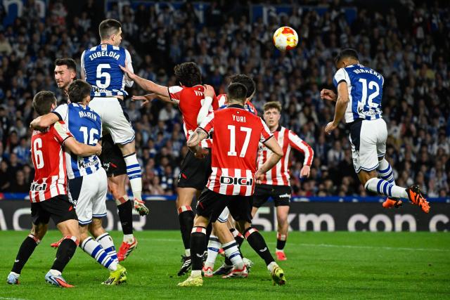 Real Sociedad's Spanish defender #12 Javi Lopez (R) heads the ball during the Copa del Rey (King's Cup) semi final second leg football match between Real Sociedad and Athletic Club Bilbao at thep Anoeta Stadium in San Sebastian on March 4, 2026. (Photo by ANDER GILLENEA / AFP)