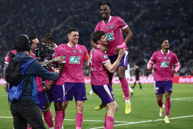 Toulouse's English defender #04 Charlie Cresswell is congratulated by teammates after scoring a goal during the French Cup quarter final football match between Olympique de Marseille (OM) and Toulouse FC at the Stade Velodrome stadium in Marseille, southern France on March 4, 2026. (Photo by Thibaud MORITZ / AFP)