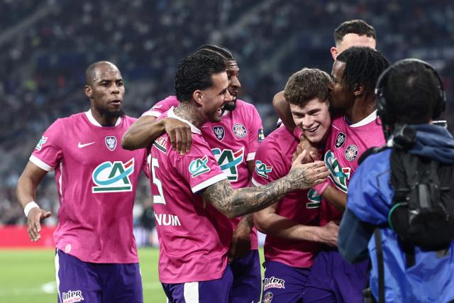 Toulouse's English defender #04 Charlie Cresswell is congratulated by teammates after scoring a goal during the French Cup quarter final football match between Olympique de Marseille (OM) and Toulouse FC at the Stade Velodrome stadium in Marseille, southern France on March 4, 2026. (Photo by Thibaud MORITZ / AFP)