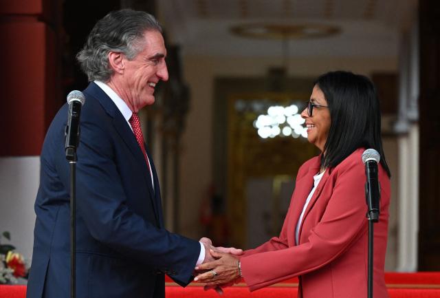 Venezuela’s interim president, Delcy Rodriguez, shakes hands with US Interior Secretary Doug Burgum after their meeting at the Miraflores Presidential Palace in Caracas on March 4, 2026. US Interior Secretary Doug Burgum on March 4, 2026,  became the latest senior Trump administration official to visit Venezuela, as Washington pushes to ramp up oil and mineral production in the country. (Photo by Federico PARRA / AFP)
