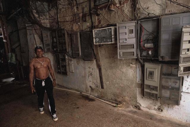 A man walks past electrical panels after a blackout in Havana on March 4, 2026. (Photo by Yamil LAGE / AFP)