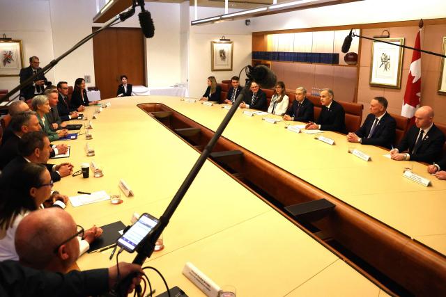 Canadian Prime Minister Mark Carney (R) and his delegation hold talks with Australian Prime Minister Anthony Albanese at Parliament House in Canberra on March 5, 2026, during his official visit to Australia. (Photo by David GRAY / AFP)