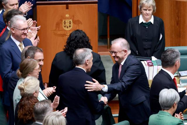 Prime Minister Anthony Albanese (R) welcomes Canadian Prime Minister Mark Carney ahead of his address to a parliamentary session in Canberra on March 5, 2026, during Carney’s official visit to Australia. (Photo by DAVID GRAY / AFP)