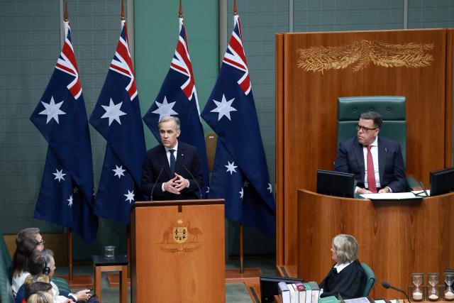 Canadian Prime Minister Mark Carney (C) addresses a parliamentary session in Canberra on March 5, 2026, during his official visit to Australia. (Photo by DAVID GRAY / AFP)