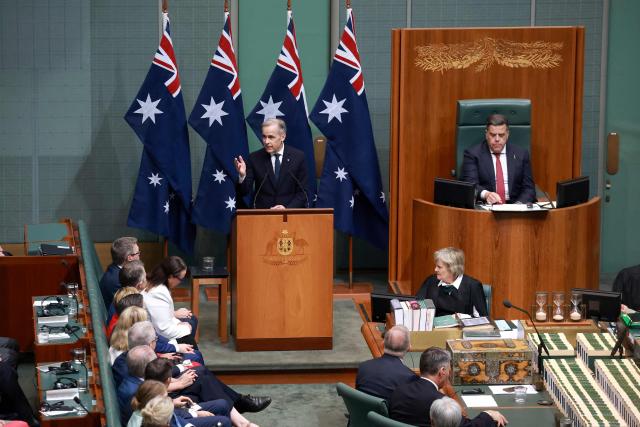 Canadian Prime Minister Mark Carney (C) addresses a parliamentary session in Canberra on March 5, 2026, during his official visit to Australia. (Photo by DAVID GRAY / AFP)