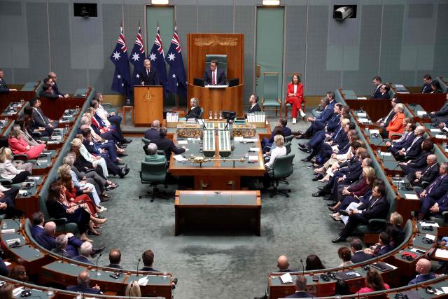 Canadian Prime Minister Mark Carney (C) addresses a parliamentary session in Canberra on March 5, 2026, during his official visit to Australia. (Photo by David GRAY / AFP)