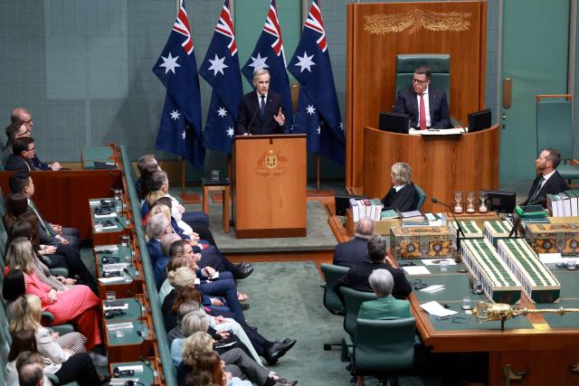 Canadian Prime Minister Mark Carney (C) addresses a parliamentary session in Canberra on March 5, 2026, during his official visit to Australia. (Photo by DAVID GRAY / AFP)