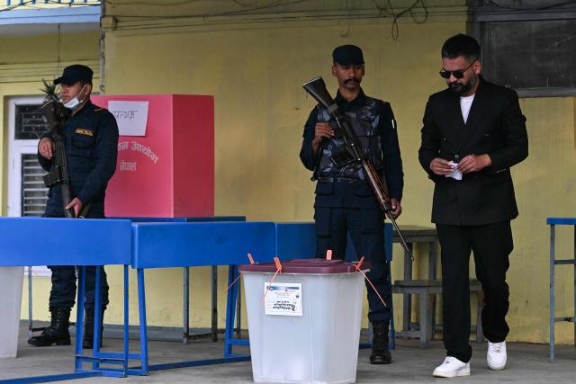 Rastriya Swatantra Party (RSP) election candidate Balendra Shah (R) prepares to cast his ballots to vote at a polling station during Nepal's parliamentary election in Kathmandu on March 5, 2026. Nepal voted on March 5 for a new parliament, six months after deadly anti-corruption protests toppled the government -- a high-stakes showdown between an entrenched old guard and a powerful youth movement. (Photo by TAUSEEF MUSTAFA / AFP)