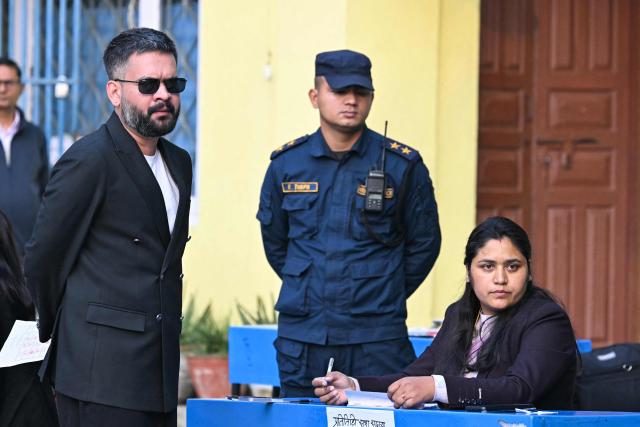 Rastriya Swatantra Party (RSP) election candidate Balendra Shah (L) waits to vote at a polling station during Nepal's parliamentary election in Kathmandu on March 5, 2026. Nepal voted on March 5 for a new parliament, six months after deadly anti-corruption protests toppled the government -- a high-stakes showdown between an entrenched old guard and a powerful youth movement. (Photo by TAUSEEF MUSTAFA / AFP)