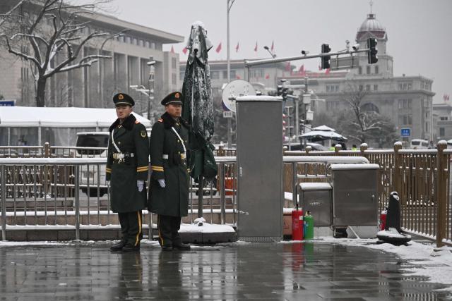 Chinese paramilitary policemen stand guard near the Great Hall of the People, venue for the opening session of the National People's Congress (NPC), in Beijing on March 5, 2026. (Photo by Pedro PARDO / AFP)