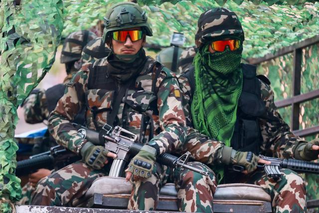 Security are seen on patrol as polls open for Nepal's parliamentary election in Kathmandu on March 5, 2026. Nepal voted on March 5 for a new parliament, six months after deadly anti-corruption protests toppled the government -- a high-stakes showdown between an entrenched old guard and a powerful youth movement. (Photo by PRABIN RANABHAT / AFP)