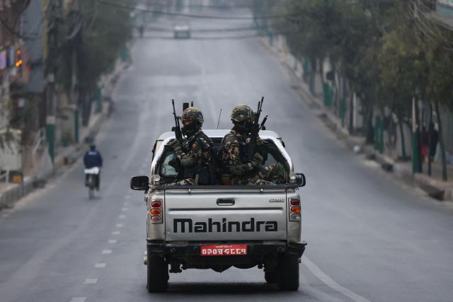 Security are seen on patrol as polls open for Nepal's parliamentary election in Kathmandu on March 5, 2026. Nepal voted on March 5 for a new parliament, six months after deadly anti-corruption protests toppled the government -- a high-stakes showdown between an entrenched old guard and a powerful youth movement. (Photo by PRABIN RANABHAT / AFP)