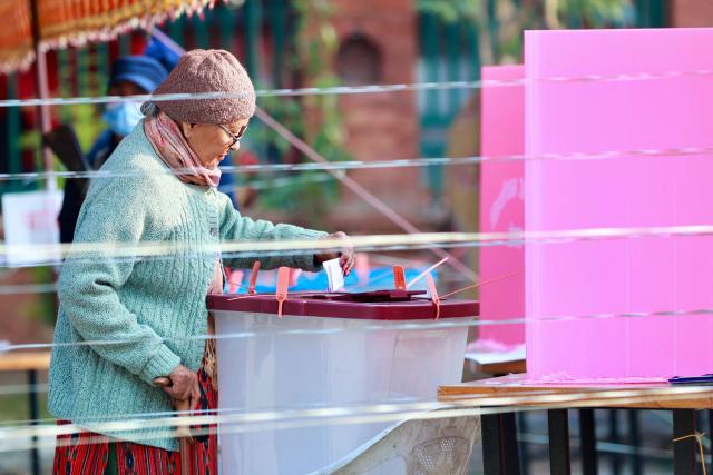 A woman casts her ballots as she votes at a polling station during Nepal's parliamentary election in Kathmandu on March 5, 2026. Nepal voted on March 5 for a new parliament, six months after deadly anti-corruption protests toppled the government -- a high-stakes showdown between an entrenched old guard and a powerful youth movement. (Photo by PRABIN RANABHAT / AFP)