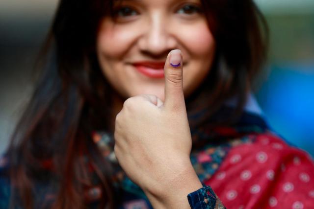 A voter shows her inked thumb after casting her ballot at a polling station during Nepal's parliamentary election in Kathmandu on March 5, 2026. Nepal voted on March 5 for a new parliament, six months after deadly anti-corruption protests toppled the government -- a high-stakes showdown between an entrenched old guard and a powerful youth movement. (Photo by PRABIN RANABHAT / AFP)