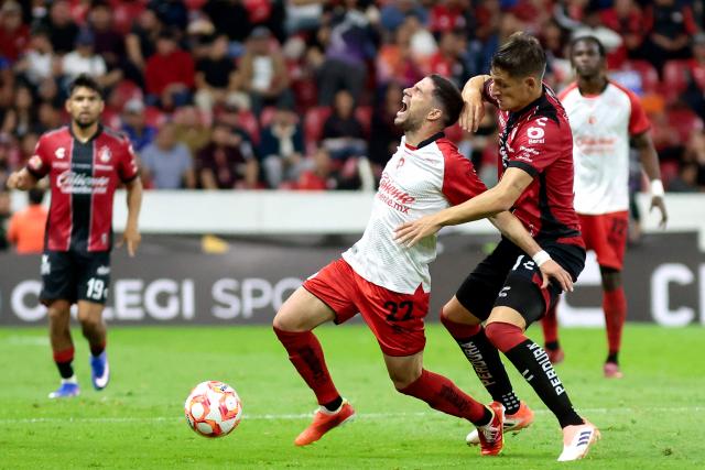 Tijuana's Uruguayan midfielder #22 Ignacio Rivero and Atlas' Argentine defender #21 Rodrigo Schlegel fight for the ball during the Liga MX Clausura football match between Atlas and Tijuana at the Jalisco Stadium in Guadalajara, state of Jalisco, Mexico on March 4, 2026. (Photo by Ulises Ruiz / AFP)