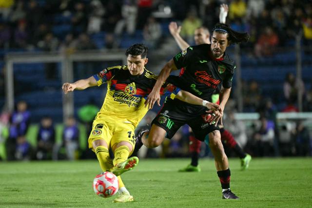 America's defender #18 Aaron Mejia kicks the ball past Juarez's midfielder #10 Rodolfo Pizarro during the Liga MX Clausura match between America and Juarez at Ciudad de los Deportes Stadium in Mexico City on March 4, 2026. (Photo by Yuri CORTEZ / AFP)
