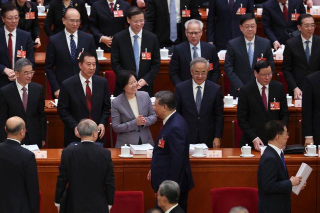 Chinese President Xi Jinping leaves at the end of the opening session of the National People's Congress (NPC) at the Great Hall of the People in Beijing on March 5, 2026. (Photo by FLORENCE LO / POOL / AFP)