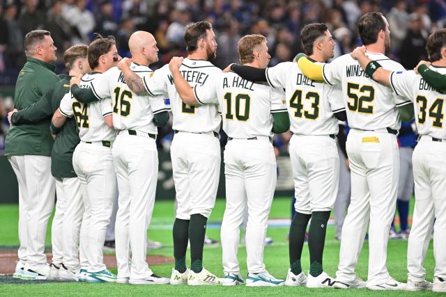 Australia's players observe their national anthem before the start of the World Baseball Classic (WBC) Pool C first round game between Australia and Taiwan at the Tokyo Dome on March 5, 2026. (Photo by Kazuhiro NOGI / AFP)