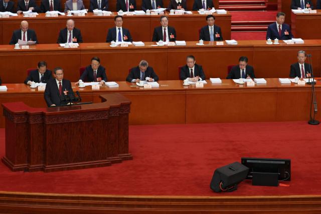 Chinese Premier Li Qiang delivers a work report during the opening session of the National People's Congress (NPC) at the Great Hall of the People in Beijing on March 5, 2026. (Photo by FLORENCE LO / POOL / AFP)