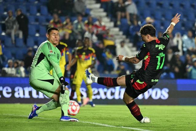 America's goalkeeper #01 Luis Malagon makes a save past Juarez's forward #17 Luca Martinez Dupuy during the Liga MX Clausura match between America and Juarez at Ciudad de los Deportes Stadium in Mexico City on March 4, 2026. (Photo by Yuri CORTEZ / AFP)