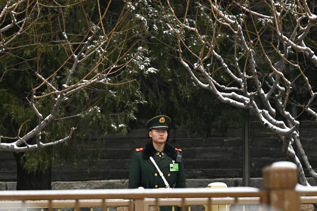A Chinese paramilitary policeman stands guard near the Great Hall of the People, venue for the opening session of the National People's Congress (NPC), in Beijing on March 5, 2026. (Photo by Pedro PARDO / AFP)
