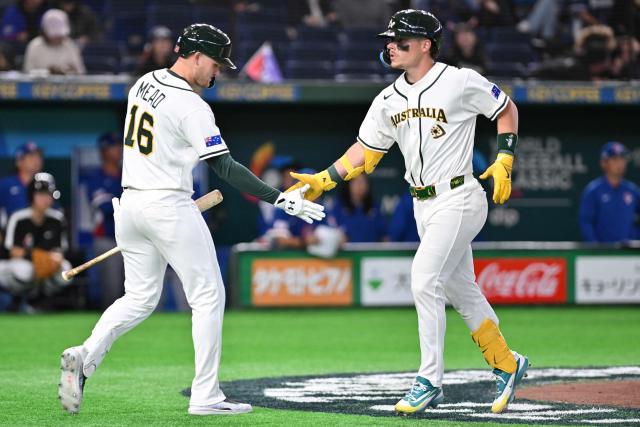 Australia's Travis Bazzana (R) celebrates his home run with teammate Curtis Mead (L) in the seventh inning of the World Baseball Classic (WBC) Pool C first round game between Australia and Taiwan at the Tokyo Dome on March 5, 2026. (Photo by Kazuhiro NOGI / AFP)
