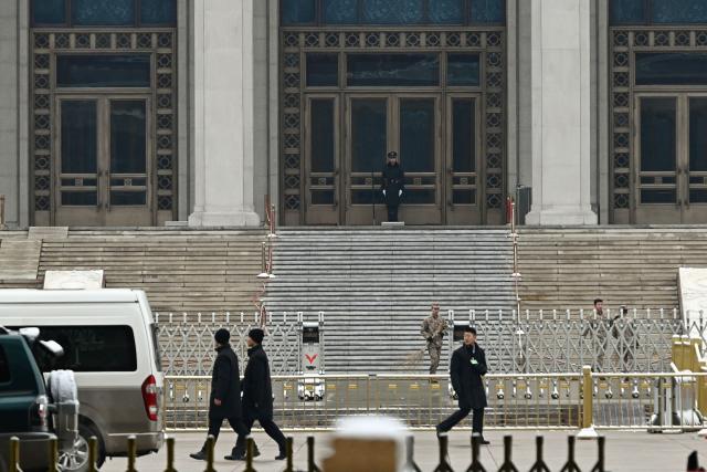 A Chinese paramilitary policeman guards the Mausoleum of late communist leader Mao Zedong near the Great Hall of the People, venue for the opening session of the National People's Congress (NPC), in Beijing on March 5, 2026. (Photo by Pedro PARDO / AFP)