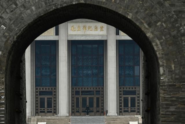 A Chinese paramilitary policeman guards the Mausoleum of late communist leader Mao Zedong near the Great Hall of the People, venue for the opening session of the National People's Congress (NPC), in Beijing on March 5, 2026. (Photo by Pedro PARDO / AFP)