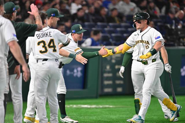 Australia's Travis Bazzana (R) celebrates his home run with teammates in the seventh inning of the World Baseball Classic (WBC) Pool C first round game between Australia and Taiwan at the Tokyo Dome on March 5, 2026. (Photo by Kazuhiro NOGI / AFP)