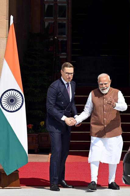 India's Prime Minister Narendra Modi (R) gestures as Finland’s President Alexander Stubb (L) arrives before their meeting at the Hyderabad House in New Delhi on March 5, 2026. (Photo by Sajjad  HUSSAIN / AFP)