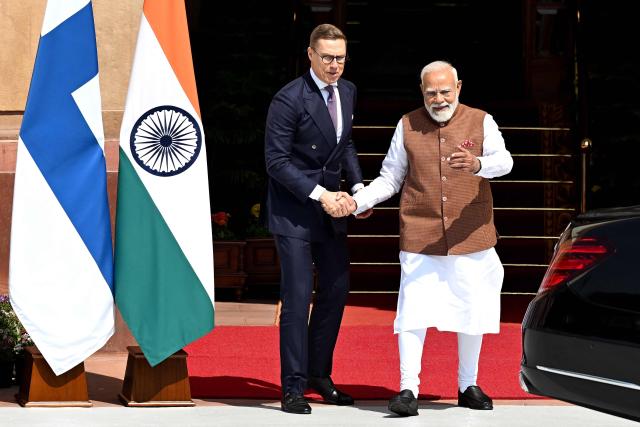 India's Prime Minister Narendra Modi (R) gestures as Finland’s President Alexander Stubb (L) arrives before their meeting at the Hyderabad House in New Delhi on March 5, 2026. (Photo by Sajjad  HUSSAIN / AFP)