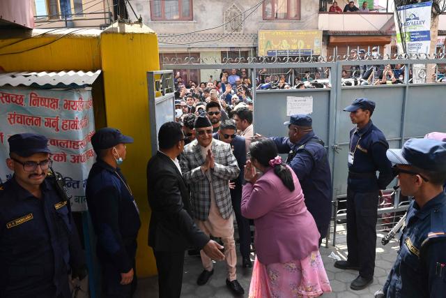 Nepal's former prime minister and Communist Party of Nepal-Unified Marxist Leninist (CPN-UML) leader Khadga Prasad Sharma Oli (C) arrives to cast his vote at a polling station during Nepal's parliamentary election in Kathmandu on March 5, 2026. Nepal voted on March 5 for a new parliament in a high-stakes showdown between an entrenched old guard and a powerful youth movement, six months after deadly anti-corruption protests toppled the government. (Photo by PRAKASH MATHEMA / AFP)