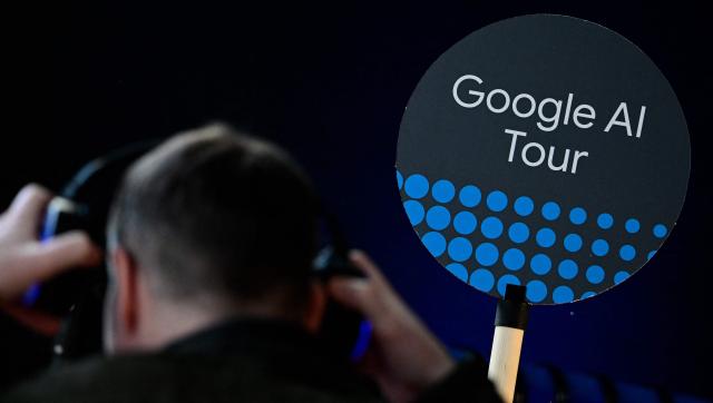 A journalist puts on earphones during the opening of a Google AI-Centre in Berlin on March 5, 2026. Google opens an AI centre in Berlin, the latest sign of Europe's deepening reliance on US firms in cutting edge technologies despite the continent's stated aim to catch up with its rivals. Germany's ministry for digital affairs told AFP the centre will bring together cloud computing and data infrastructure, "AI development" operations as well as a space for cooperation between start-ups and research centres. (Photo by Tobias SCHWARZ / AFP)