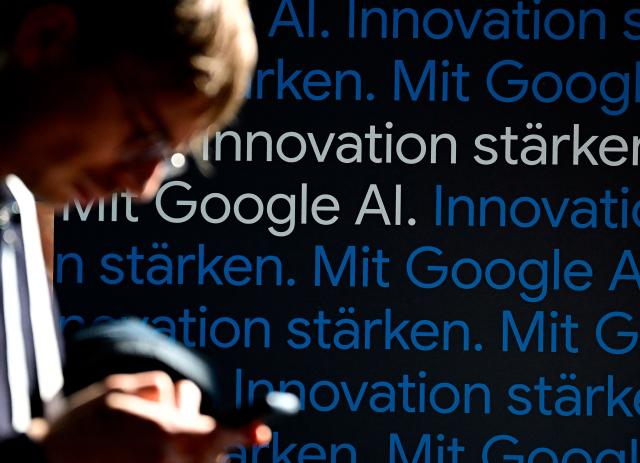 A journalist is pictured during the opening of a Google AI-Centre in Berlin on March 5, 2026. Google opens an AI centre in Berlin on Thursday, the latest sign of Europe's deepening reliance on US firms in cutting edge technologies despite the continent's stated aim to catch up with its rivals. Germany's ministry for digital affairs told AFP the centre will bring together cloud computing and data infrastructure, "AI development" operations as well as a space for cooperation between start-ups and research centres. (Photo by Tobias SCHWARZ / AFP)