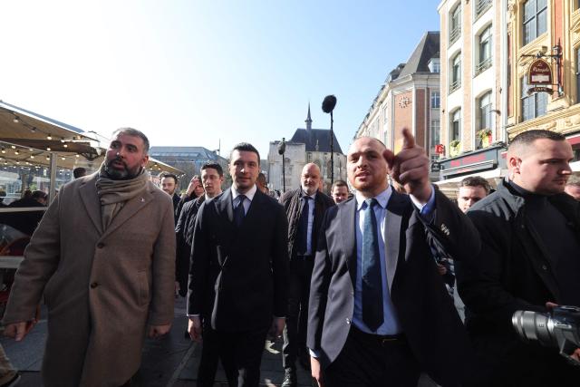 President of French far-right party Rassemblement National (RN) Jordan Bardella (C-L) walks before a campaign meeting to support Rassemblement National (RN)'s Lille mayoral candidate Matthieu Valet (C-R), ahead of France's upcoming municipal elections in Lille, northern France on March 5, 2026. (Photo by Francois LO PRESTI / AFP)